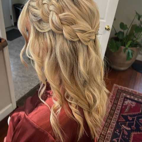 a thick braided half updo with waves