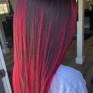 vivid red hair color that extends to the end of this long hairstyle